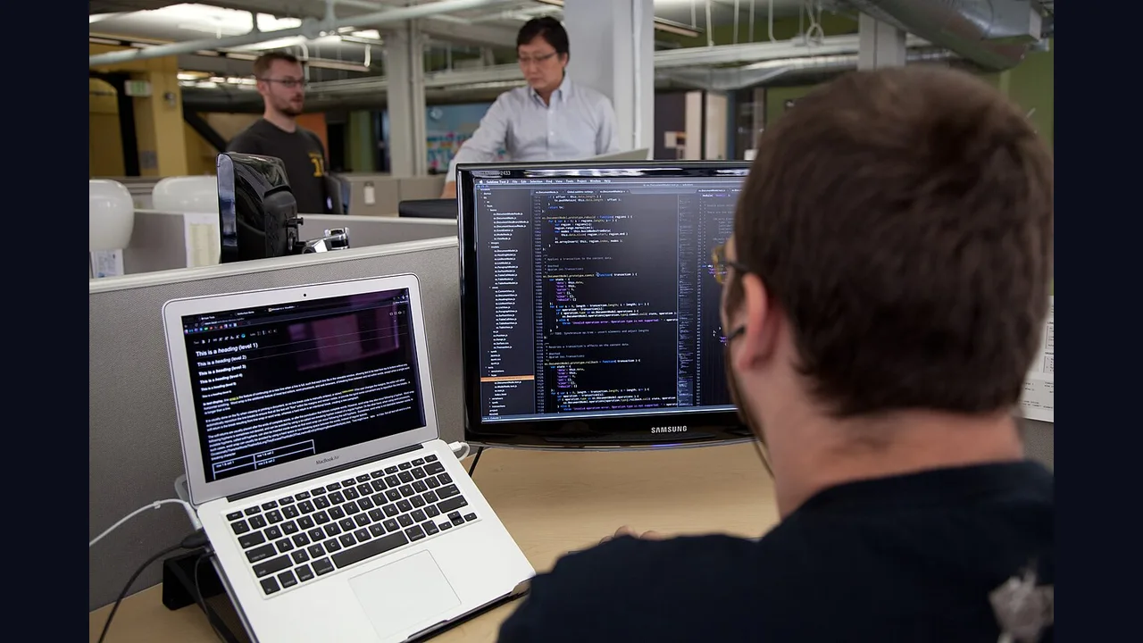 A programmer working at a computer terminal
